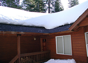 Heating element installed under roof shingles.